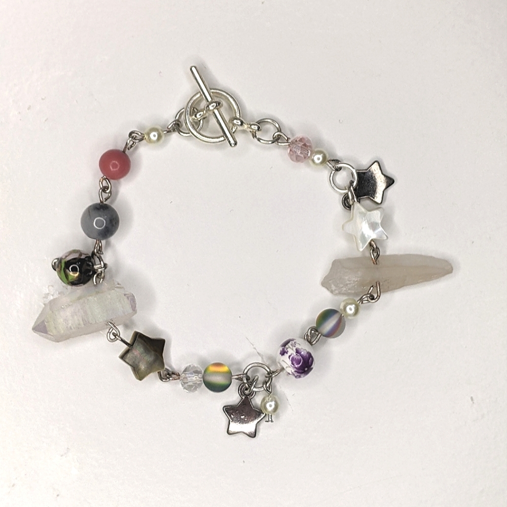 Bracelet with pink and crystal beads charms and a toggle clasp. Handmade by me.